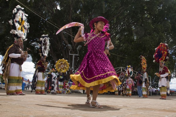 Doña Marina. People speaking Zapotec in Oaxaca's central valleys built towns with palaces, temples, ball courts. and markets, coexisting and sometimes fighting with each other until 1457. That year, the Aztec tlatoani, or ruler, Moctezuma invaded. First he conquered the towns inhabited by Mixtecs, then those of the Zapotecs. The Aztec invasion halted when Hernando Cortes arrived in the Yucatan, traveling up the coast of Tabasco in 1519. Cortes made alliances with the Aztecs' enemies and marched on Tenochtitlan, their capital, massacring thousands of indigenous people at Cholula on the way. By then, the first Moctezuma was dead. The second Moctezuma let Cortes and his soldiers into the city. Moctezuma was then taken hostage and later murdered. The city's inhabitants rose up, forcing Cortes to flee, but they won only temporary respite. Cortes laid siege to Tenochtitlan and finally destroyed it, burying the huge temple pyramid under what is now Mexico City's main cathedral and central plaza, the Zocalo. Moctezuma's successor, Cuauhtemoc, was eventually captured, and, with his death, the Aztec empire crumbled.