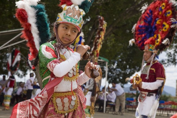 The symbols of nationalism incorporated into the dance. Martin, so the legend goes, invented a dance to dramatize the conquest of indigenous people by the Spaniards. Jorge Hernandez Diaz, an anthropologist at the Benito Juarez Autonomous University of Oaxaca, writes that there are three theories of the origin of the dance. In one, Martin celebrated the birth of twins by staging a fight between dancers representing the conquering Spaniards (headed by Martin himself in the role of his father) and the defeated native people. The roles of the dancers in the Dance of the Feather today are still the same: Cortes, his captains and soldiers, Moctezuma and his allies. The personality of Malinalli was split the roles of two people: Doña Marina and the Malinche.