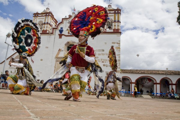 Dancers in the courtyard in front of the church. Martin's intention was to use the dance justify his rule and to emphasize to indigenous people the uselessness of resistance. But after over 450 years, the dance no longer means what it once did. If anything, it represents a spirit of resistance to those forces that would deny Zapotecs their language, dance, music, and other cultural traditions. The Dance of the Feather is one element of a broader indigenous culture maintained through hundreds of years of colonization, followed by decades of official national policies denying their culture's autonomy and value. Hernandez says, “The Dance of the Feather keeps its importance in communities that hold to the tradition, like Teotitlan del Valle, because it fulfills the function of reaffirming their cultural identity by recalling a glorious past, that is, of what the community was before the arrival of the Spanish, and what it continues to be in spite of them. The Dance prevents forgetting, because it recalls the struggle that native Zapotecs maintained with the Spanish to defend their territory, and from whom they inherited, according to the perception of the townspeople, only negative things.”