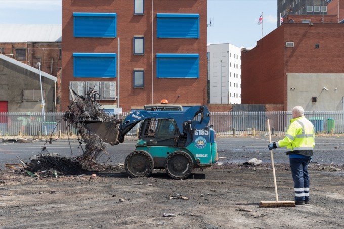 Cleaning up the after the bonfires requires multiple work crews operating over several days. This team is taking a first pass at a site near the city center.