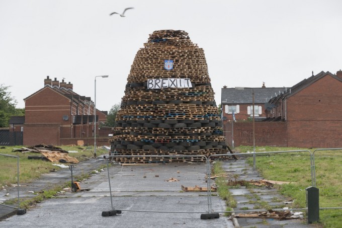 Britain’s recent vote to leave the European Union was celebrated on the Tigers Bay bonfire. The Ulster Defense Association‘s shield is displayed above the “Brexit” sign.