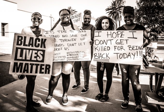 "No more hashtags," reads one sign, referencing the deaths of Philando Castile and Alton Sterling at the hands of police. Johnny Silvercloud/Flickr CC.