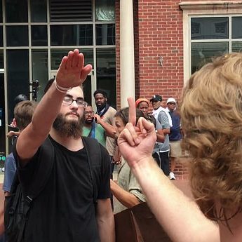 A Nazi salute is met by a counter-protester "salute" in Charlottesville, 8/12/17. Evan Nesterak/Flickr CC