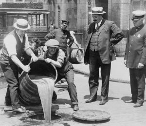 Workers in NYC destroy beer during America's period of alcohol prohibition.