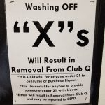 A sign in this 18+ club warns underage patrons about washing the X's, markered onto their hands by Club Q's bouncers, off to try to appear older (likely to buy alcohol).
